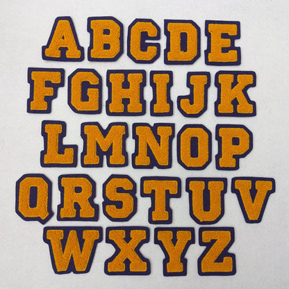 Athletic gold chenille block letter on purple colored felt.
