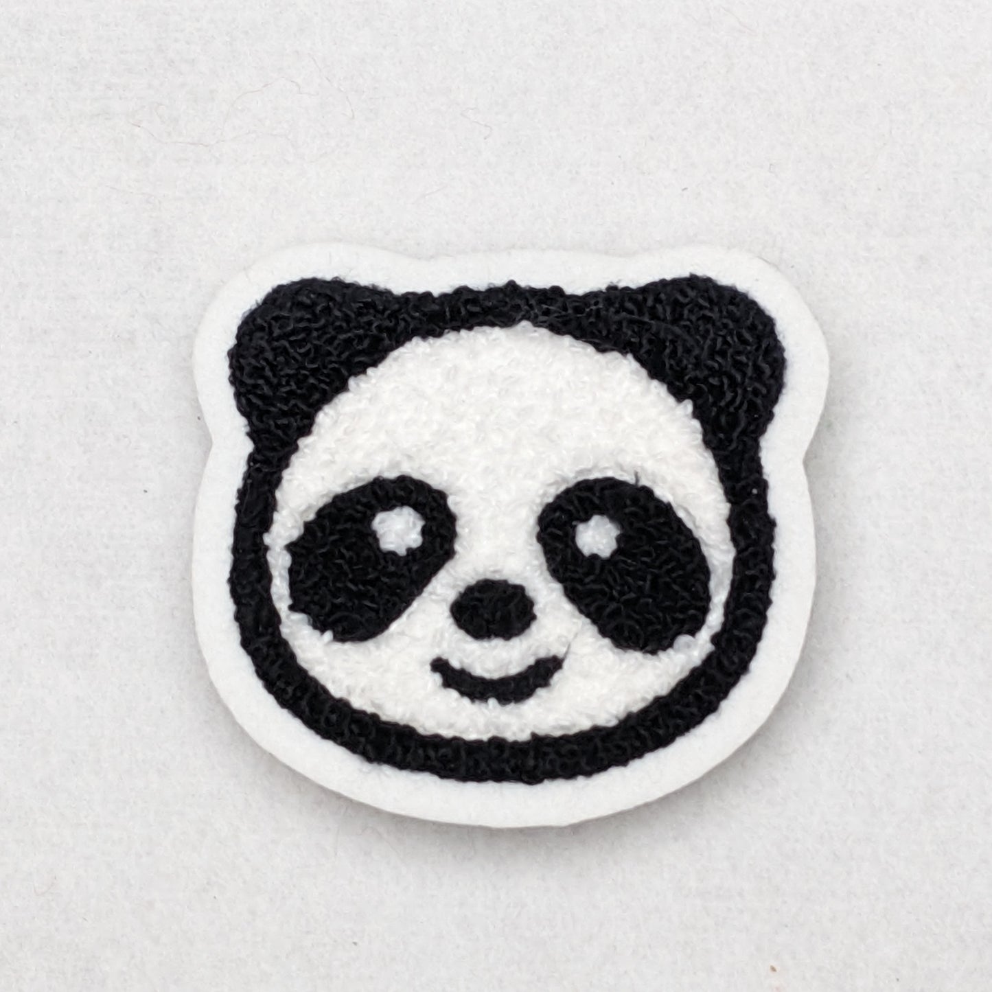 Fuzzy chenille panda patch on scrim felt.