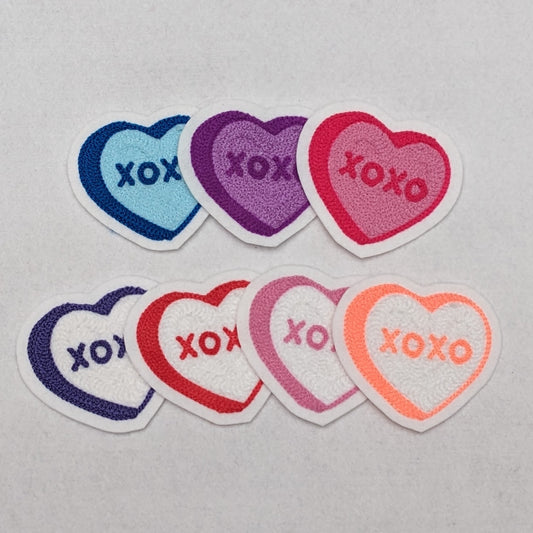 These chainstitch embroidered hearts spell out XOXO.